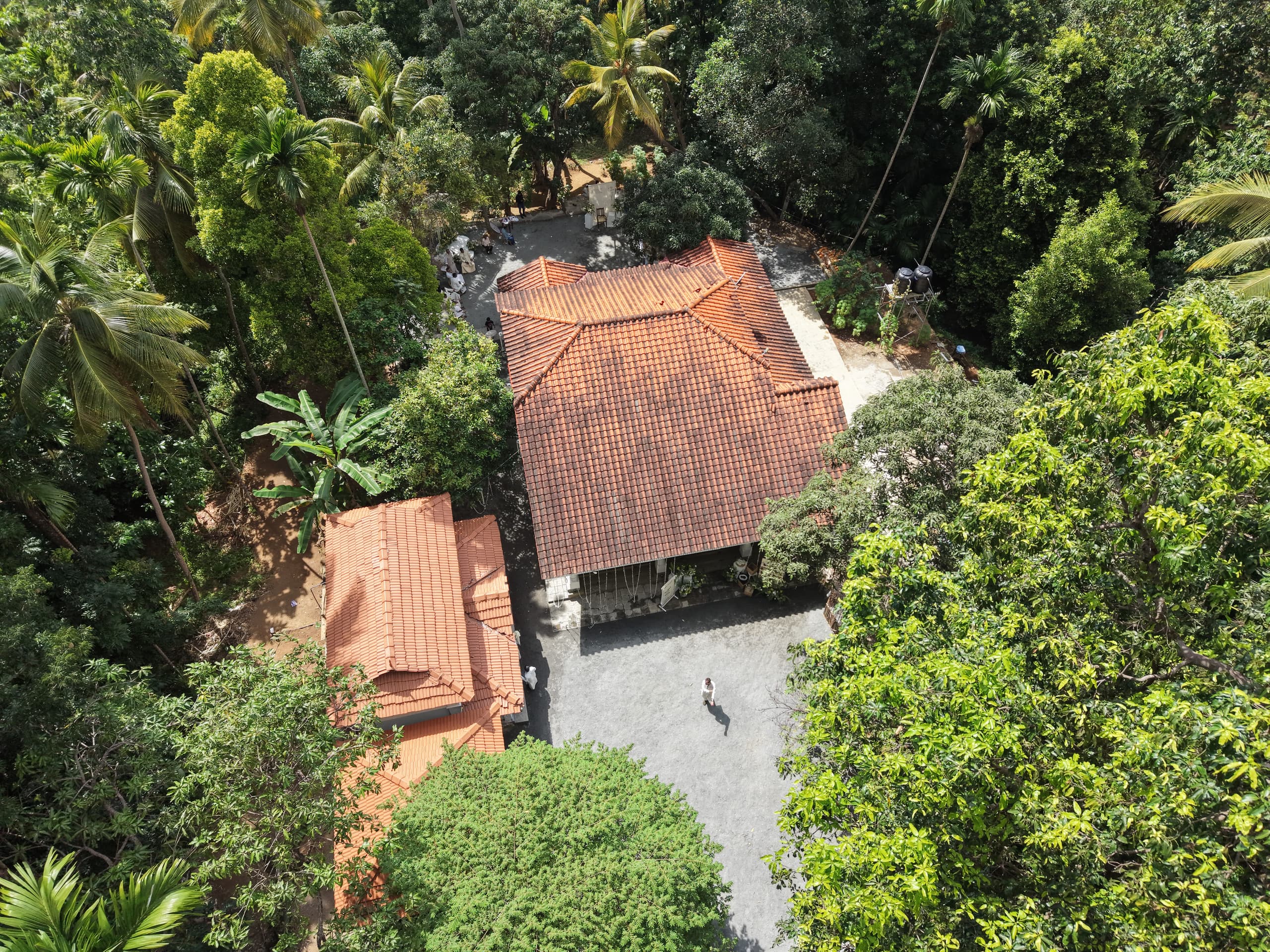 Aerial view of the walawwa roof and courtyard among tall trees