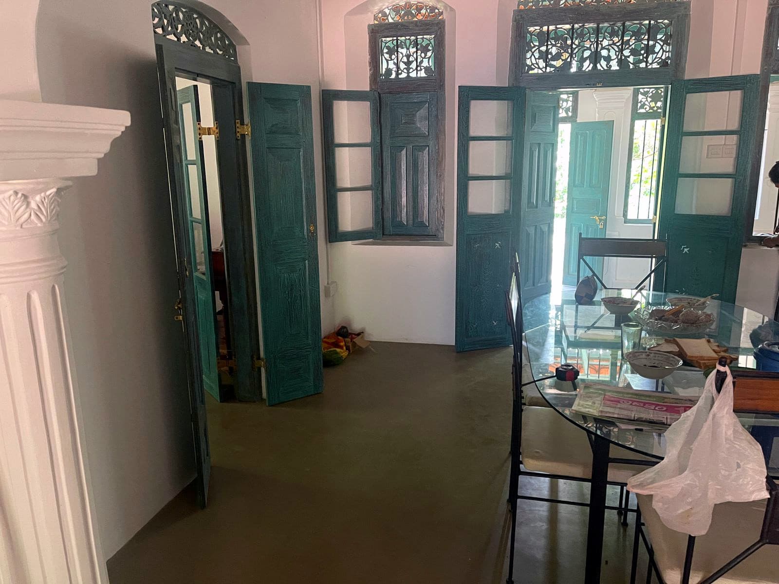 Tall carved green doors and windows opened onto the hall