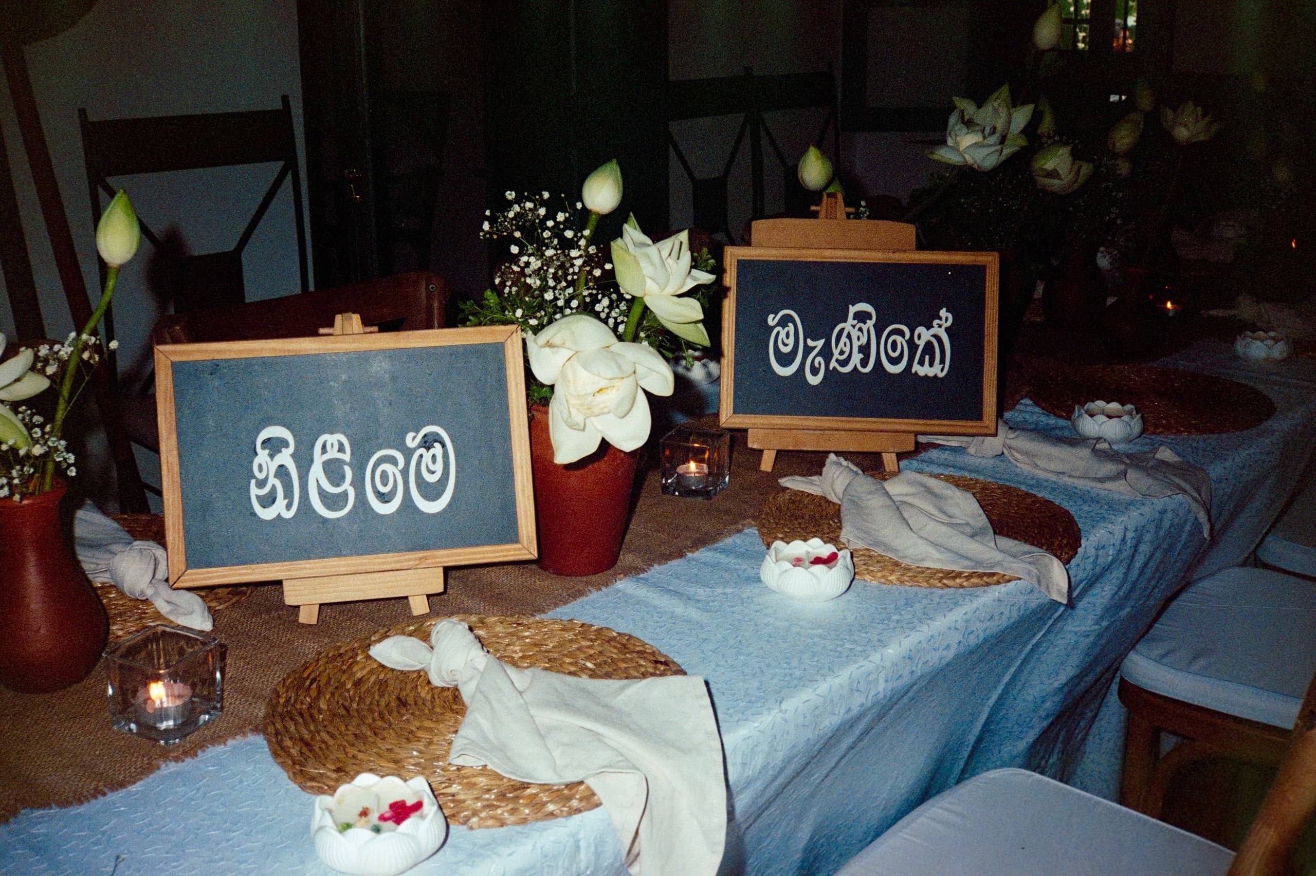 Table set with lotus flowers and Sinhala name boards